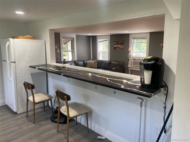 a kitchen with a table chairs refrigerator and microwave