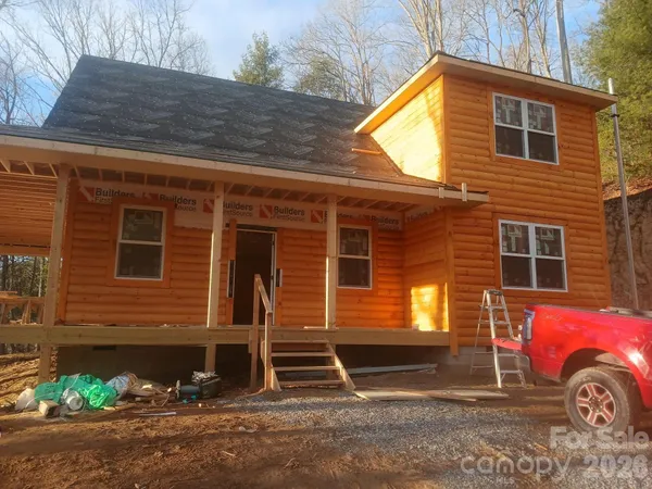 a front view of a house with parking area