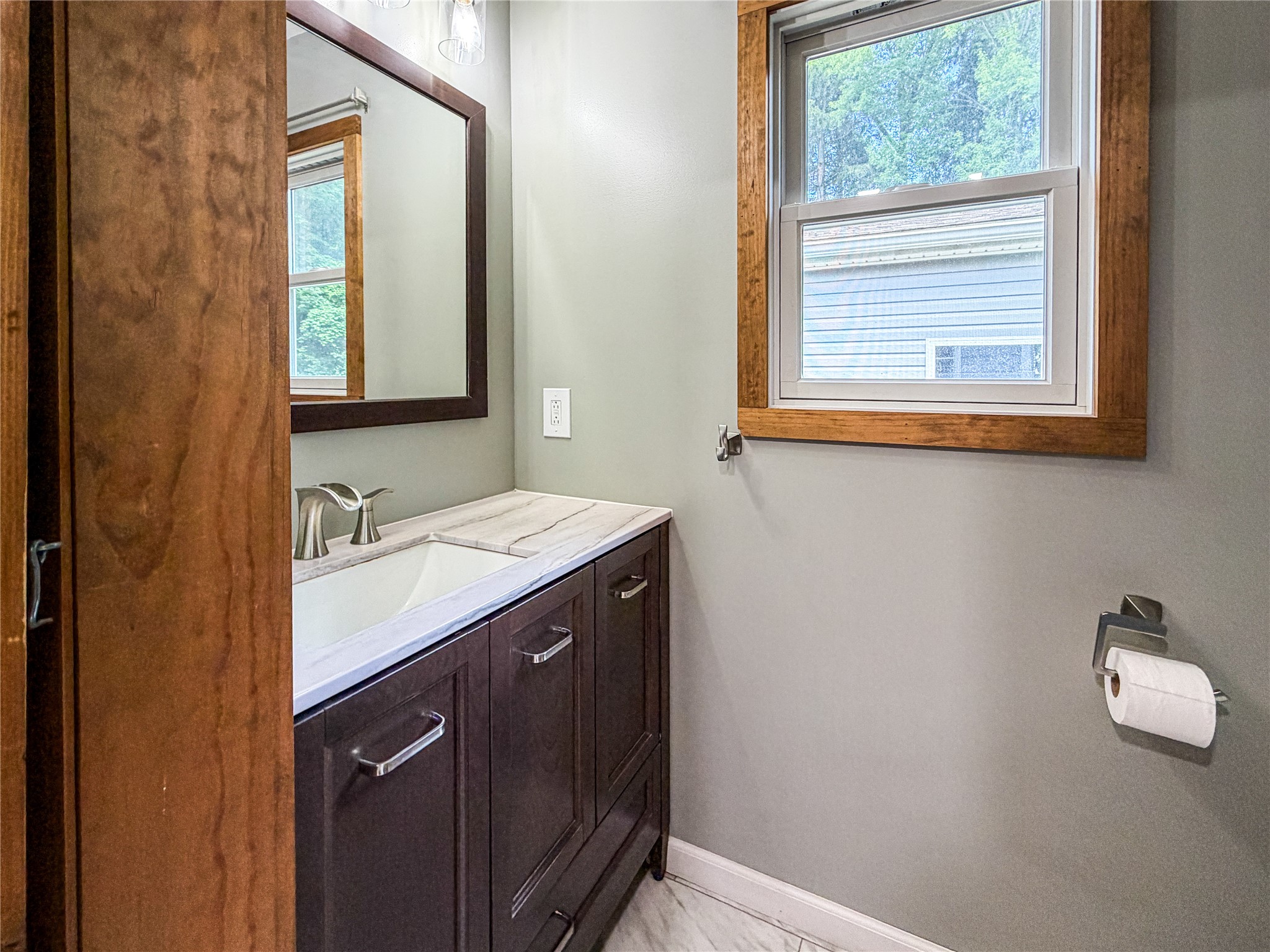 11910 Schenenberg Road Guys Mills, PA 16327 - Photo 18 of 50 Barn doors open to a powder room off the laundry area