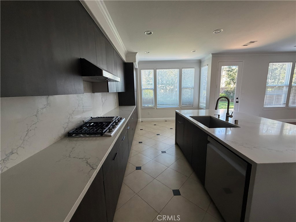 11516 Venezia Way Porter Ranch, CA 91326 - Photo 14 of 35 a kitchen with stainless steel appliances a sink stove and cabinets