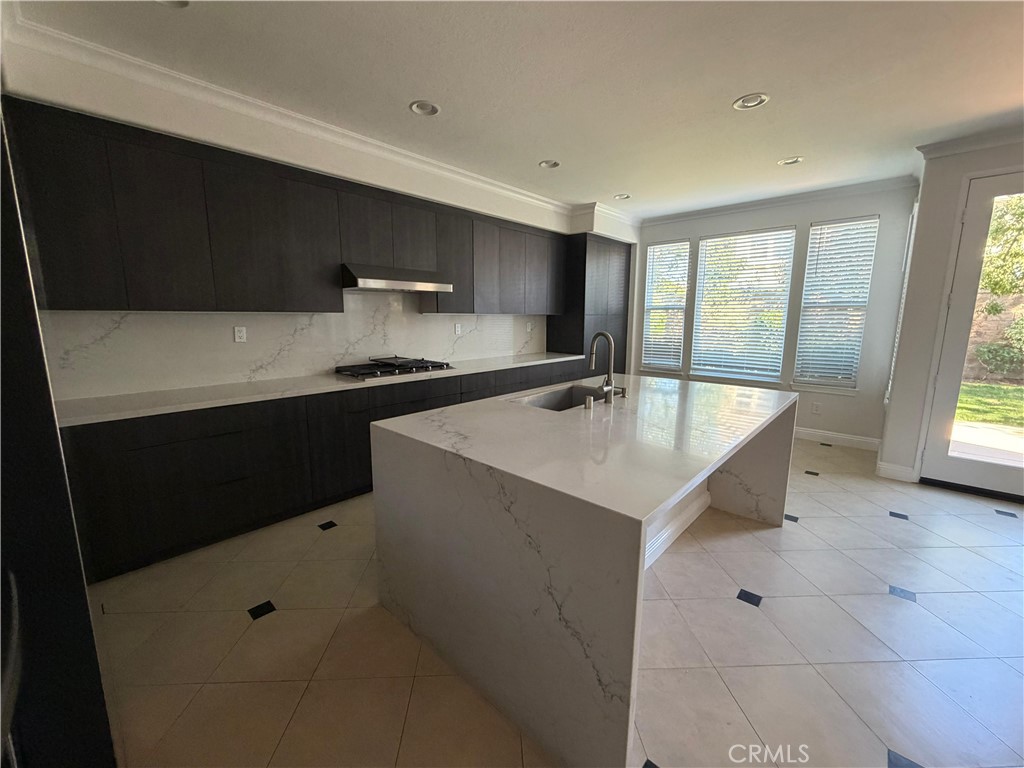 11516 Venezia Way Porter Ranch, CA 91326 - Photo 15 of 35 a kitchen with a sink window and cabinets