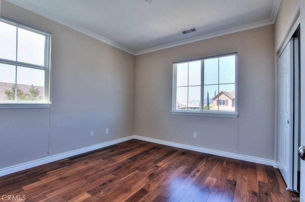 11516 Venezia Way Porter Ranch, CA 91326 - Photo 21 of 35 an empty room with wooden floor and windows