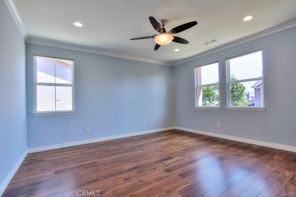 11516 Venezia Way Porter Ranch, CA 91326 - Photo 24 of 35 an empty room with wooden floor and windows