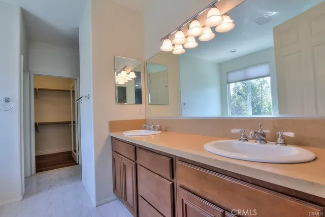a bathroom with a sink vanity and a mirror