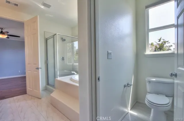 a bathroom with a bathtub and a shower