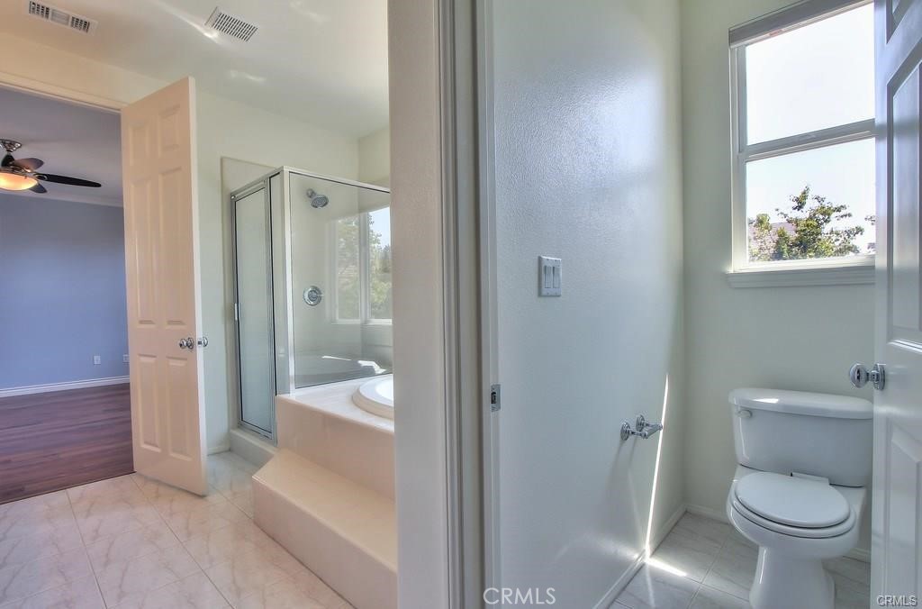 11516 Venezia Way Porter Ranch, CA 91326 - Photo 30 of 35 a bathroom with a toilet and a shower