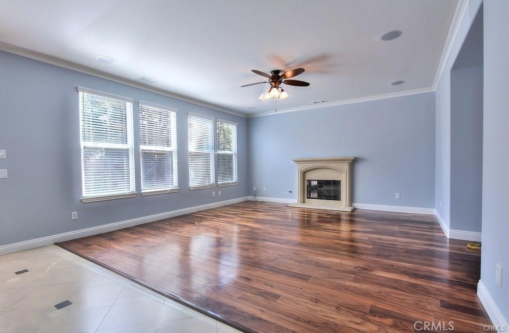 11516 Venezia Way Porter Ranch, CA 91326 - Photo 4 of 35 a view of an empty room with window and wooden floor