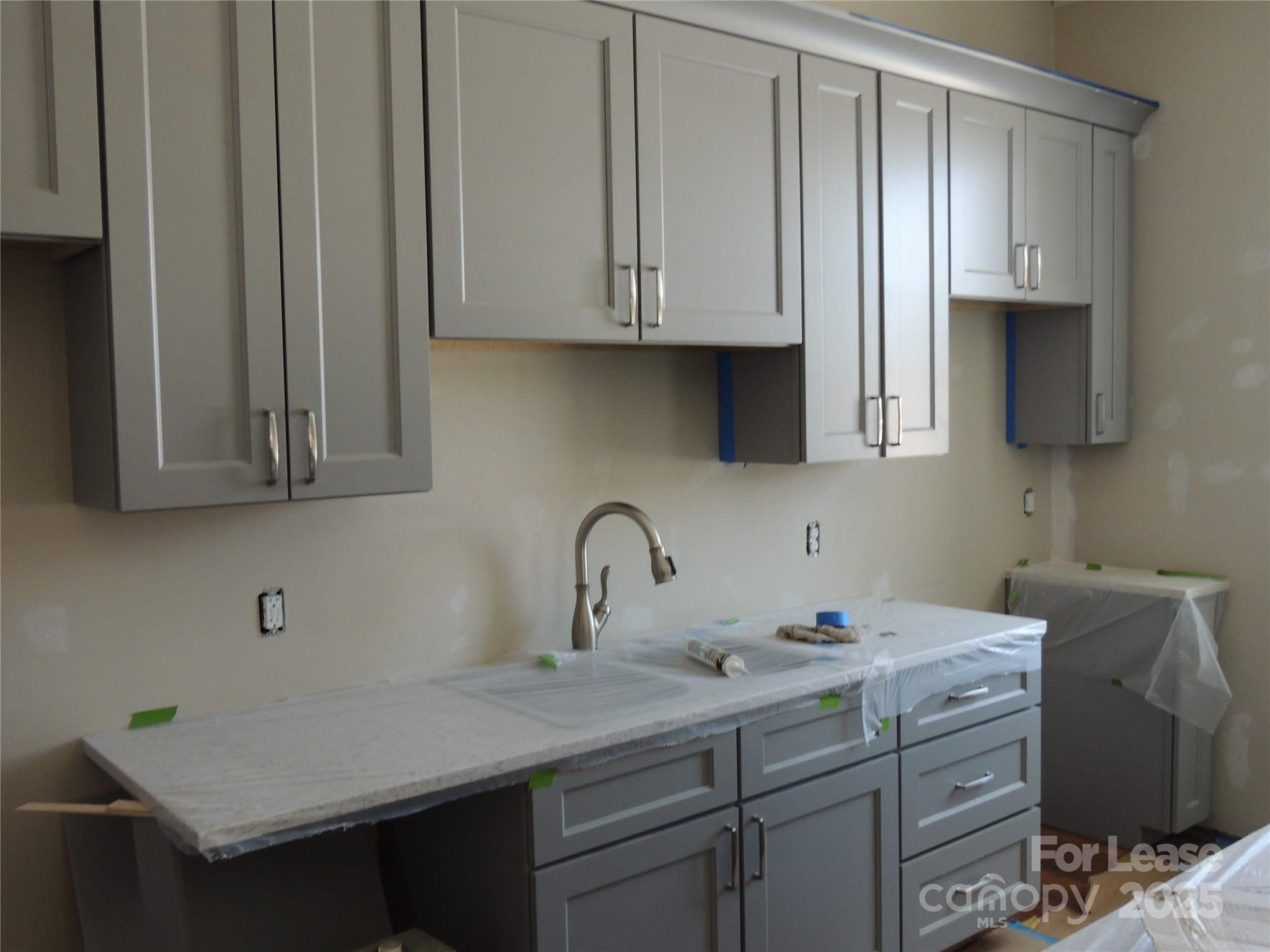 126 West Court Street Rutherfordton, NC 28139 - Photo 3 of 6 a kitchen with stainless steel appliances granite countertop a sink a stove and cabinets
