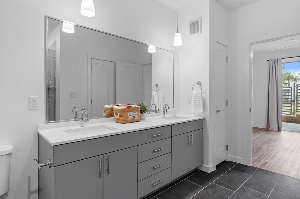 4801 Springdale Road, Unit 2010 Austin, TX 78723 - Photo 10 of 28 Bathroom featuring double vanity and dark tile patterned flooring