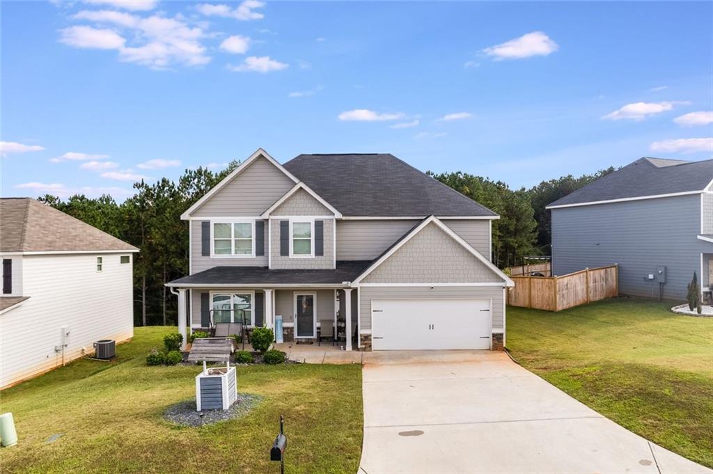 227 Waters Edge Parkway Temple, GA 30179 - Photo 1 of 26 a front view of house with yard and trees in the background