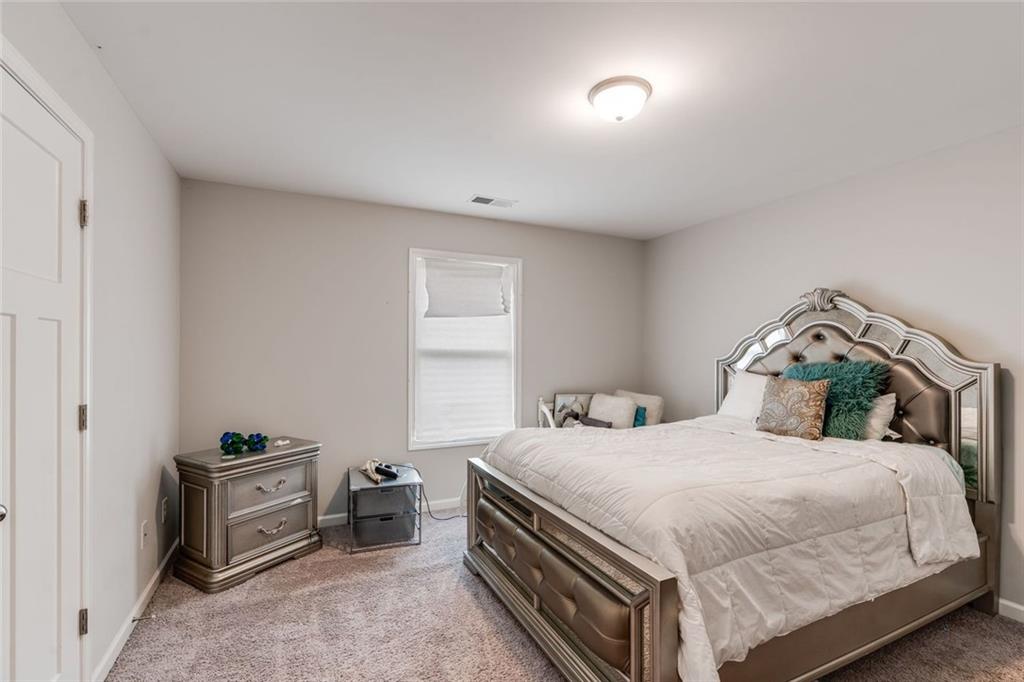 227 Waters Edge Parkway Temple, GA 30179 - Photo 12 of 26 a bedroom with a bed and a view of kitchen