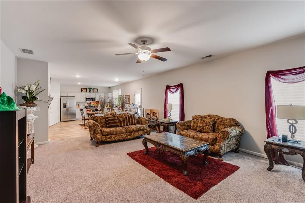 227 Waters Edge Parkway Temple, GA 30179 - Photo 21 of 26 a living room with furniture ceiling fan and a rug
