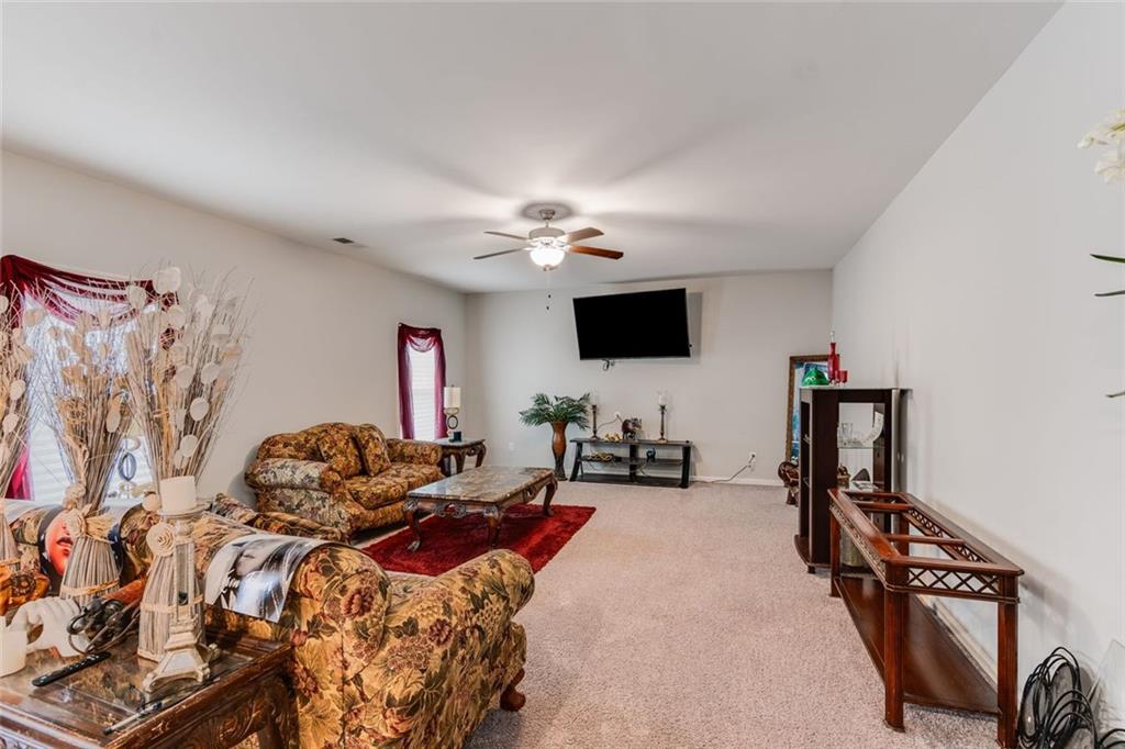227 Waters Edge Parkway Temple, GA 30179 - Photo 22 of 26 a bedroom with furniture and a flat screen tv