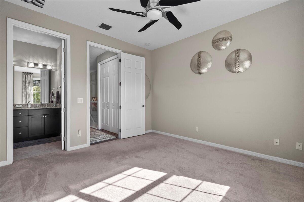 692 Southwest Glen Crest Way Stuart, FL 34997 - Photo 14 of 37 an empty room with fan and windows
