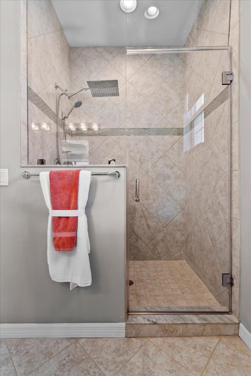 692 Southwest Glen Crest Way Stuart, FL 34997 - Photo 17 of 37 a bathroom with a shower