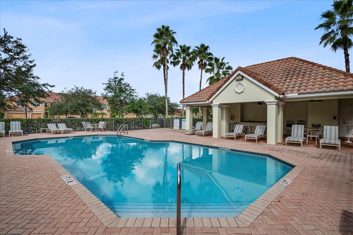 692 Southwest Glen Crest Way Stuart, FL 34997 - Photo 29 of 37 a view of a swimming pool with lounge chair