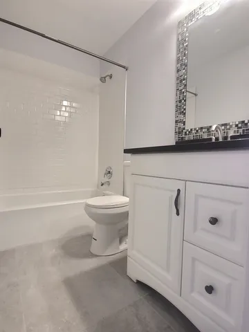 a bathroom with a sink a toilet and vanity