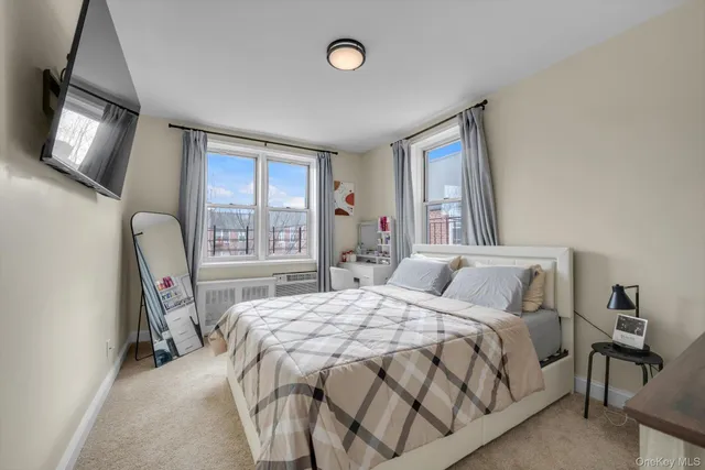 a bedroom with a bed window and chair