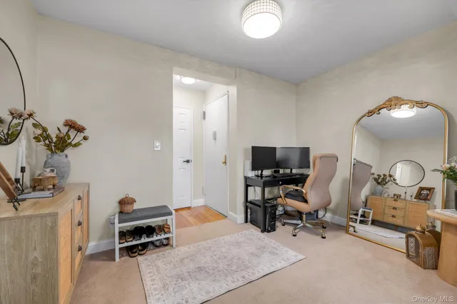 a view of a workspace with a window and lounge chair