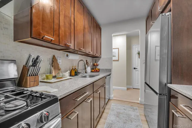 a kitchen with stainless steel appliances granite countertop a stove and a refrigerator