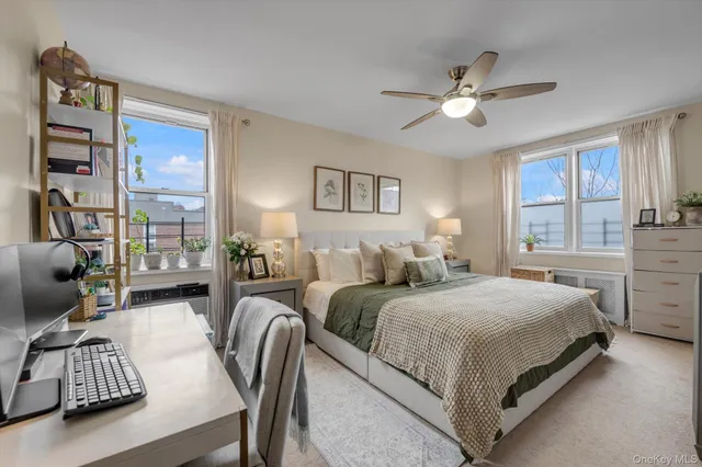 a bedroom with two beds and a chandelier