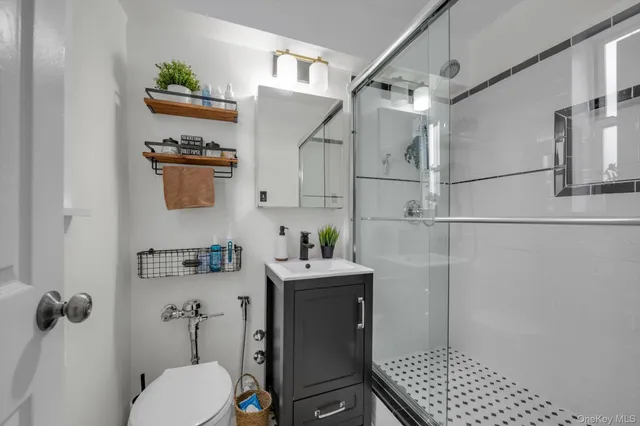 a bathroom with a sink toilet and shower