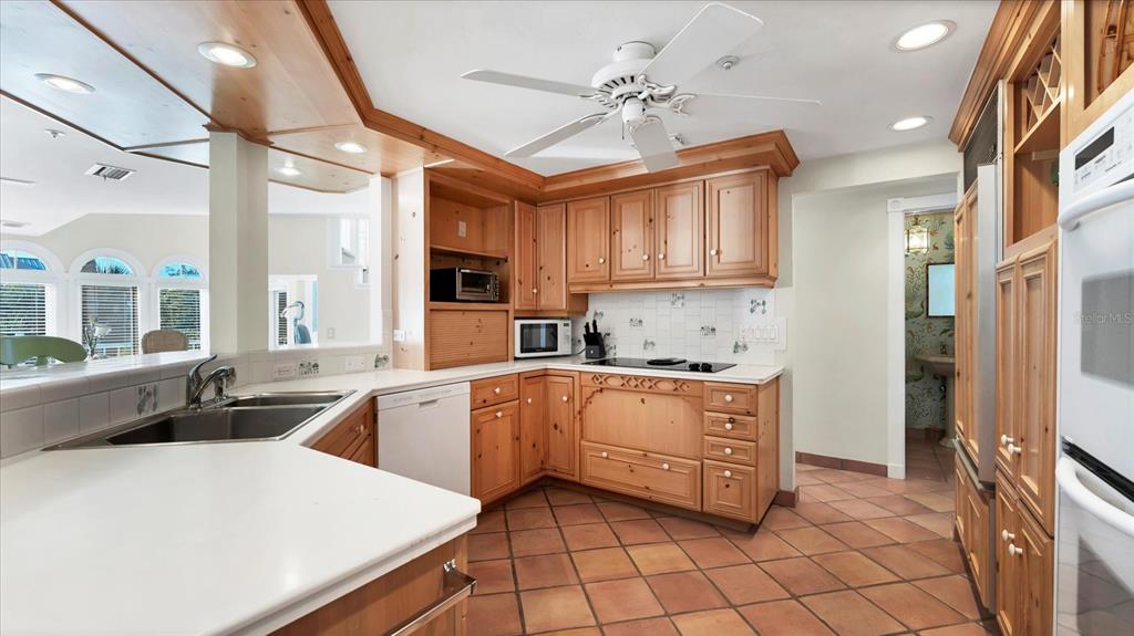 402 Lafitte Street Boca Grande, FL 33921 - Photo 11 of 40 a kitchen with stainless steel appliances granite countertop a sink window and cabinets