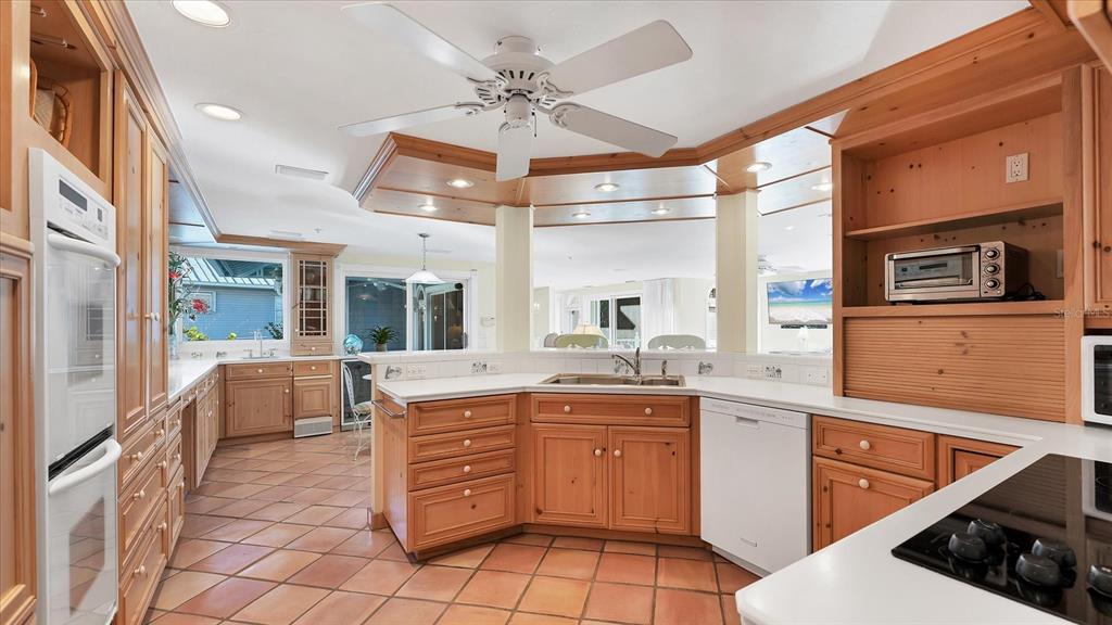 402 Lafitte Street Boca Grande, FL 33921 - Photo 12 of 40 a kitchen with a sink appliances and cabinets
