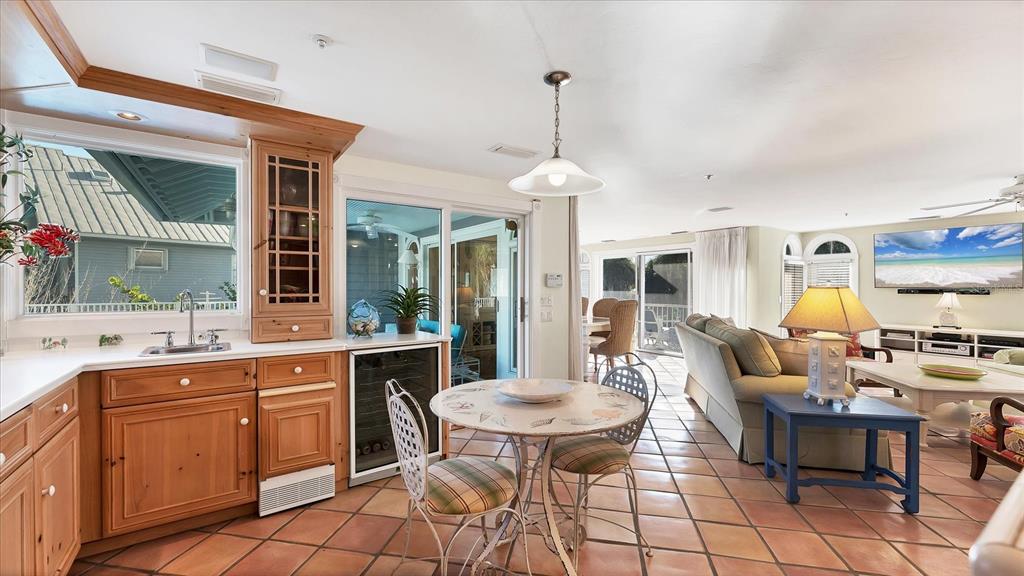 402 Lafitte Street Boca Grande, FL 33921 - Photo 13 of 40 a kitchen with a dining table chairs and white cabinets