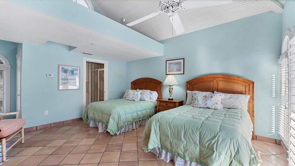402 Lafitte Street Boca Grande, FL 33921 - Photo 23 of 40 a bedroom with two beds and a lamp on dresser