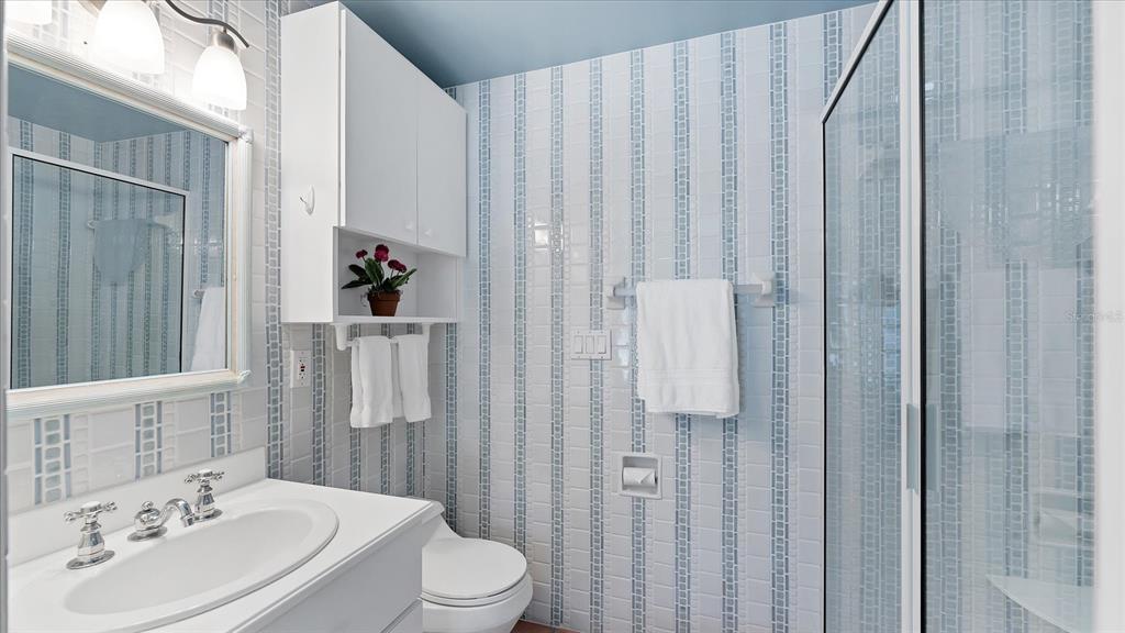 402 Lafitte Street Boca Grande, FL 33921 - Photo 24 of 40 a bathroom with a sink a toilet and shower curtain