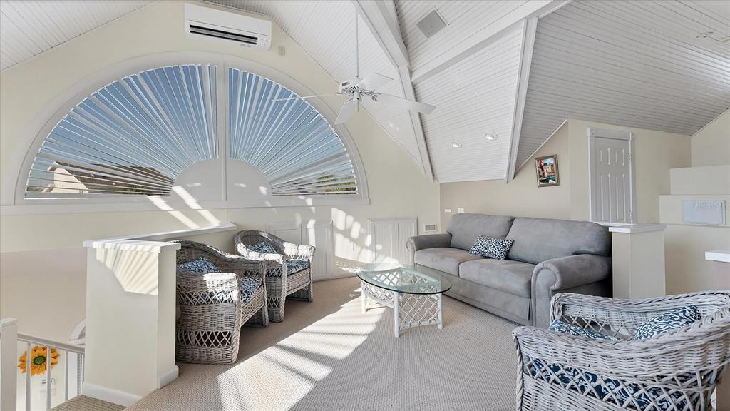 402 Lafitte Street Boca Grande, FL 33921 - Photo 28 of 40 a living room with furniture a couch and a chandelier