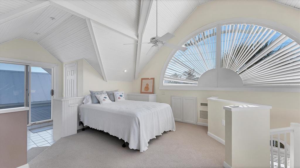 402 Lafitte Street Boca Grande, FL 33921 - Photo 29 of 40 a bedroom with a bed and a large window