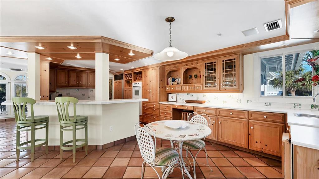402 Lafitte Street Boca Grande, FL 33921 - Photo 10 of 40 a dinning table and chairs in a kitchen