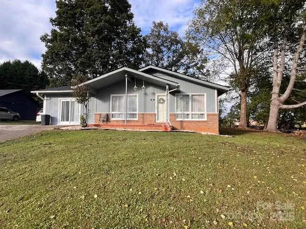 a front view of house with yard and green space