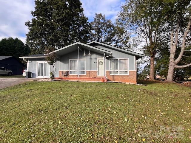 a front view of house with yard and green space