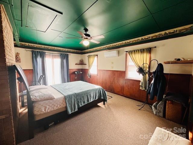90 Long Street Marion, NC 28752 - Photo 12 of 34 a bed room with a bed and a ceiling fan
