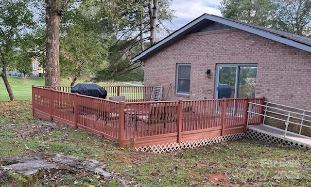 90 Long Street Marion, NC 28752 - Photo 30 of 34 a view of a house with a wooden deck and a yard