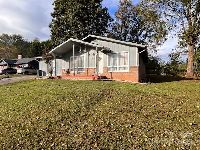 90 Long Street Marion, NC 28752 - Photo 33 of 34 a front view of a house with a yard and trees