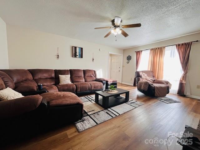 90 Long Street Marion, NC 28752 - Photo 6 of 34 a living room with furniture ceiling fan and a window