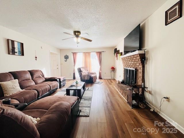 90 Long Street Marion, NC 28752 - Photo 7 of 34 a living room with furniture a flat screen tv and a fireplace