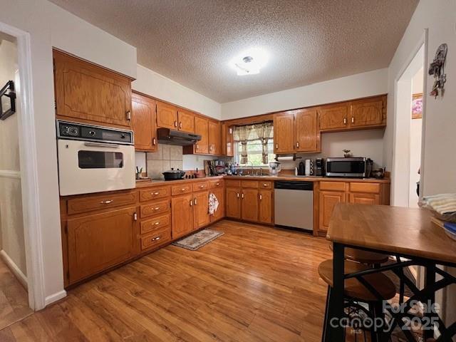 90 Long Street Marion, NC 28752 - Photo 9 of 34 a kitchen with stainless steel appliances granite countertop a sink counter space cabinets and a window