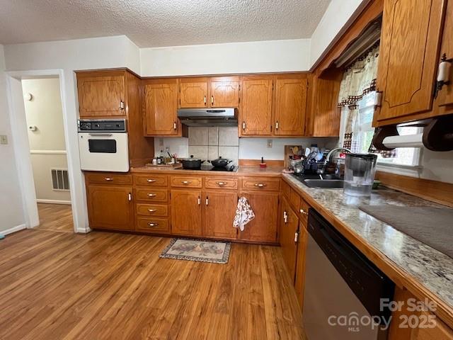 90 Long Street Marion, NC 28752 - Photo 10 of 34 a kitchen with stainless steel appliances a sink a stove top oven a counter space and cabinets
