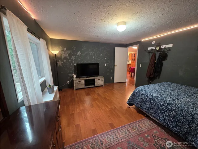 a living room with furniture flat screen tv and a fireplace