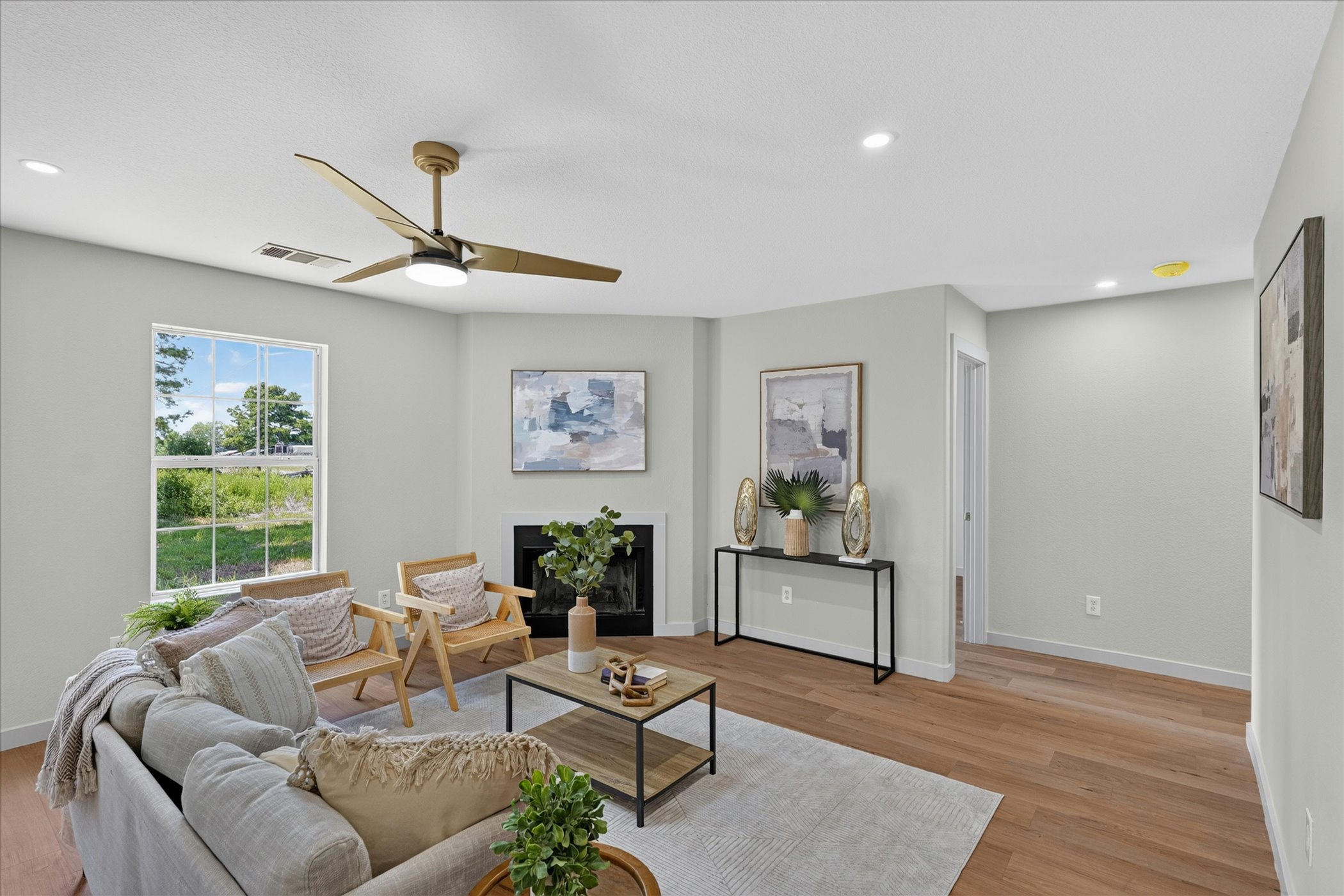 258 Pine View Loop Bastrop, TX 78602 - Photo 13 of 40 A comfortable living area with warm wood flooring and a modern ceiling fan for ultimate comfort.
