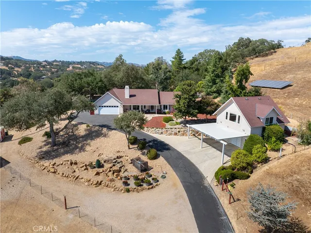 an aerial view of a house with a mountain