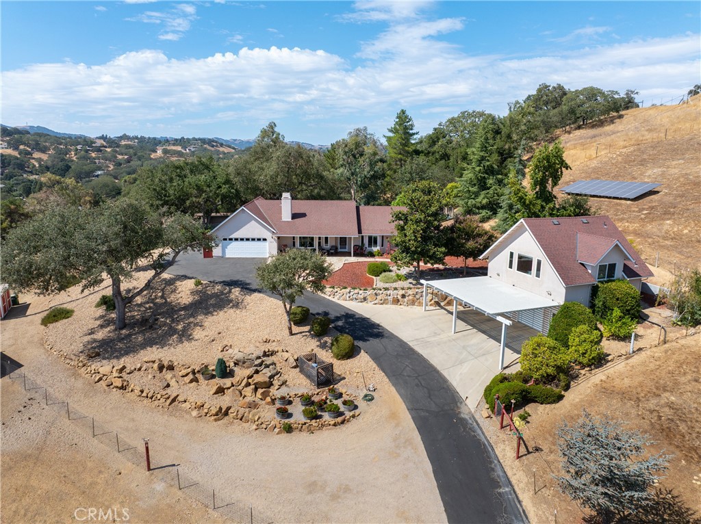 an aerial view of a house with a mountain