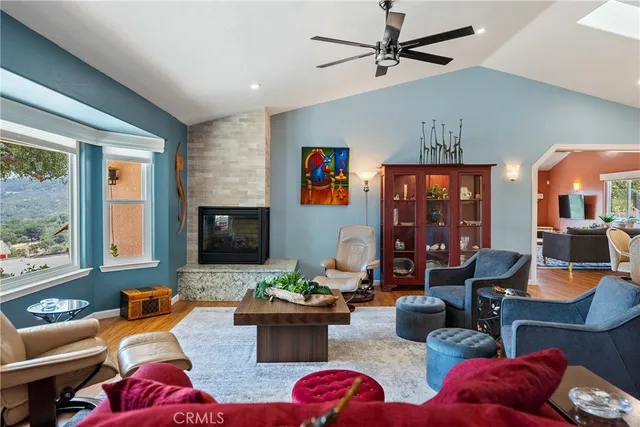a dining room with wooden floor a chandelier a wooden table and chairs