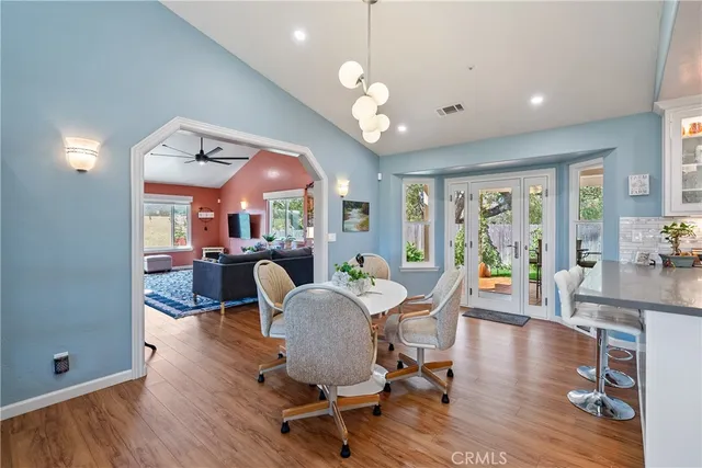 a kitchen with stainless steel appliances granite countertop a stove top oven a sink a counter space and cabinets