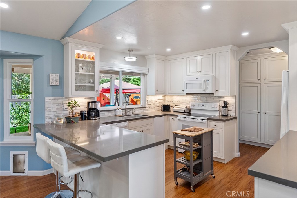 7215 San Gabriel Road Atascadero, CA 93422 - Photo 20 of 74 a kitchen with stainless steel appliances granite countertop a stove top oven a sink a counter space and cabinets
